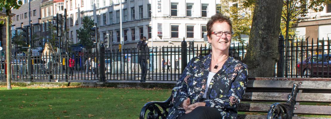 Linda Giles sitting on a bench outside Belfast City Hall